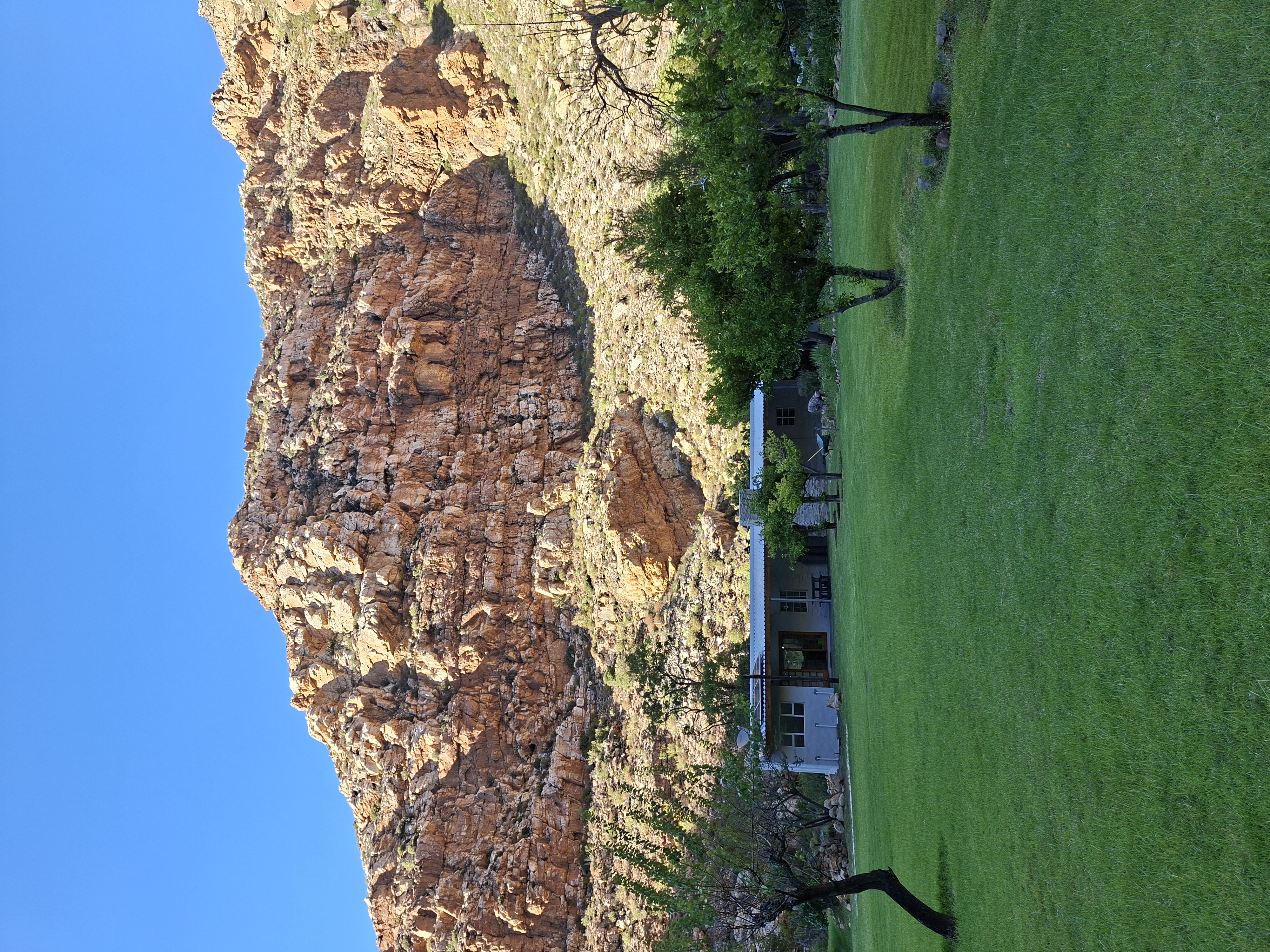 Cottage with cliff backdrop